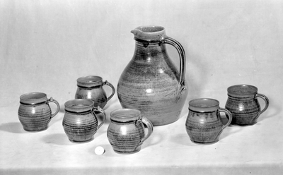 Photograph: Beer jug and six mugs by the Leach Pottery, St Ives. 