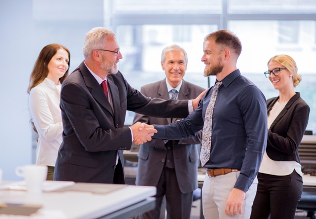 two-businessmen-shaking-hands-congratulating-promotion_23-2147923371