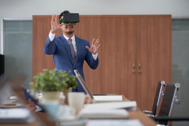 asian-ceo-suit-using-virtual-reality-headset-boardroom_1098-17753