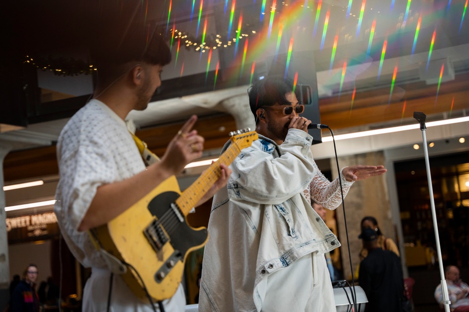 Two people performing music: a guitarist and a singer. 