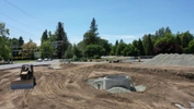 Construction site with caterpillar tractor and lines in the dirt from the work day