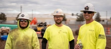 JB STEEL workers wearing neon yellow green shirts smiling for the camera