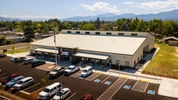 Drone shot of front of Logos charter school and parking lot half full of cars