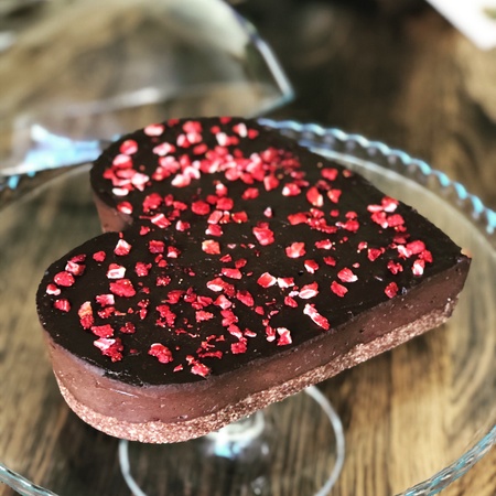 A heart shaped chocolate cake with strawberry pieces baked by Berlin's vegan food caterer, TRIVITYS