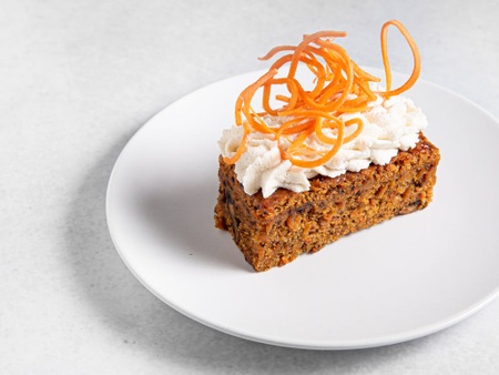 A slice of vegan carrot walnut cake baked in Berlin by MANA Food