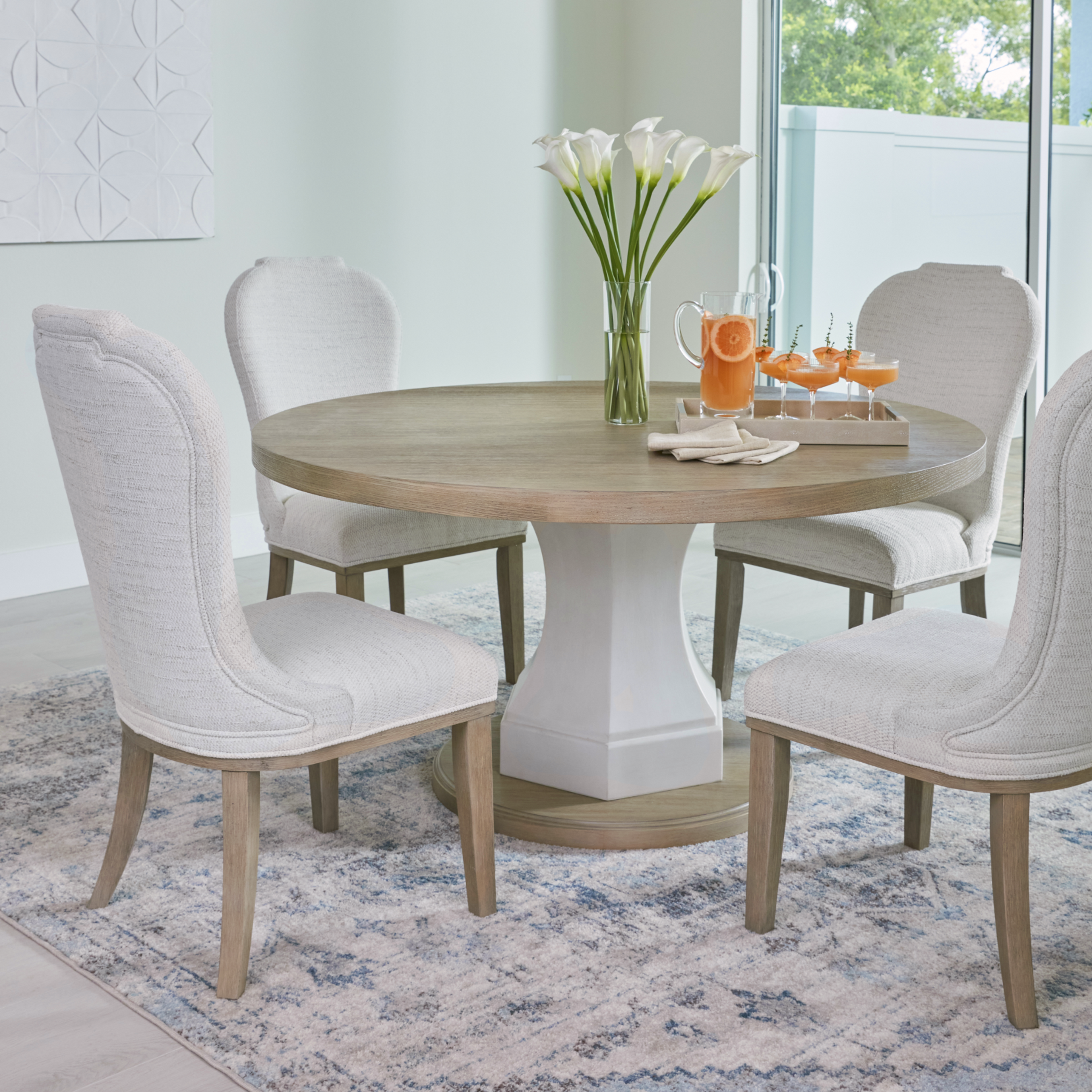 dining table with flowers and juice on top