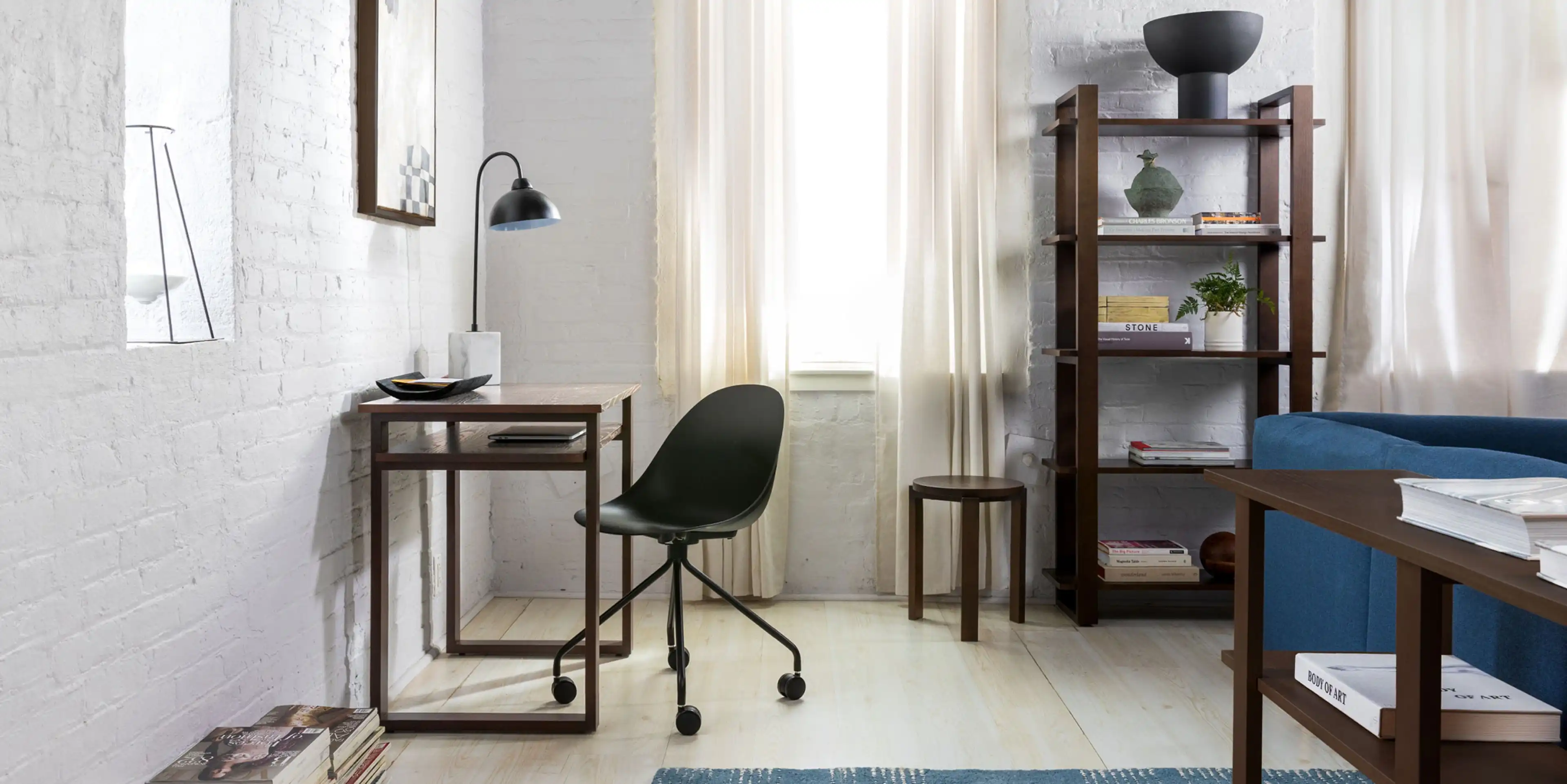 Home office set up with Index bookcase, desk, and console in walnut and Tayte office chair in black.