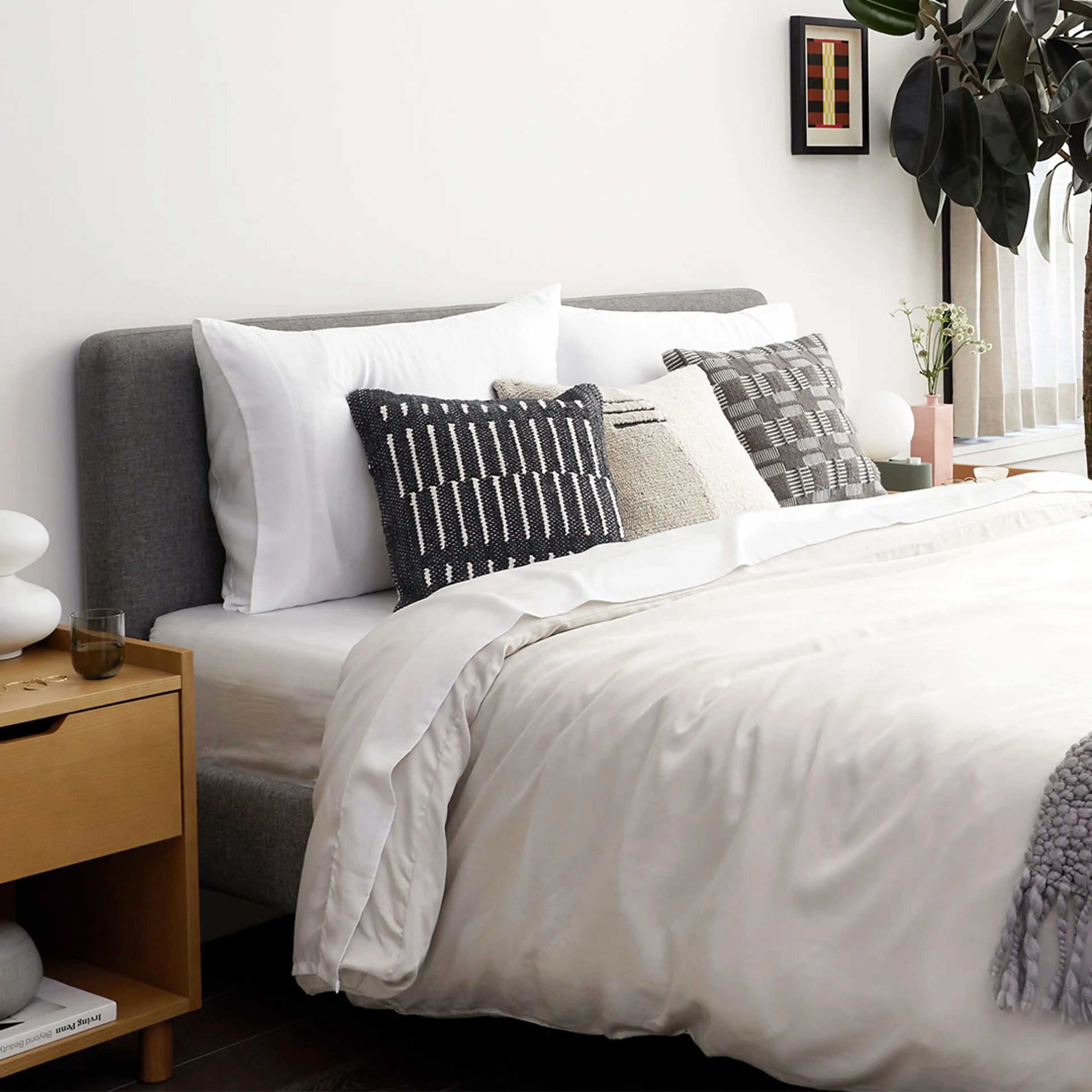 Chorus upholstered frame and headboard, with an accompanying oak nightstand