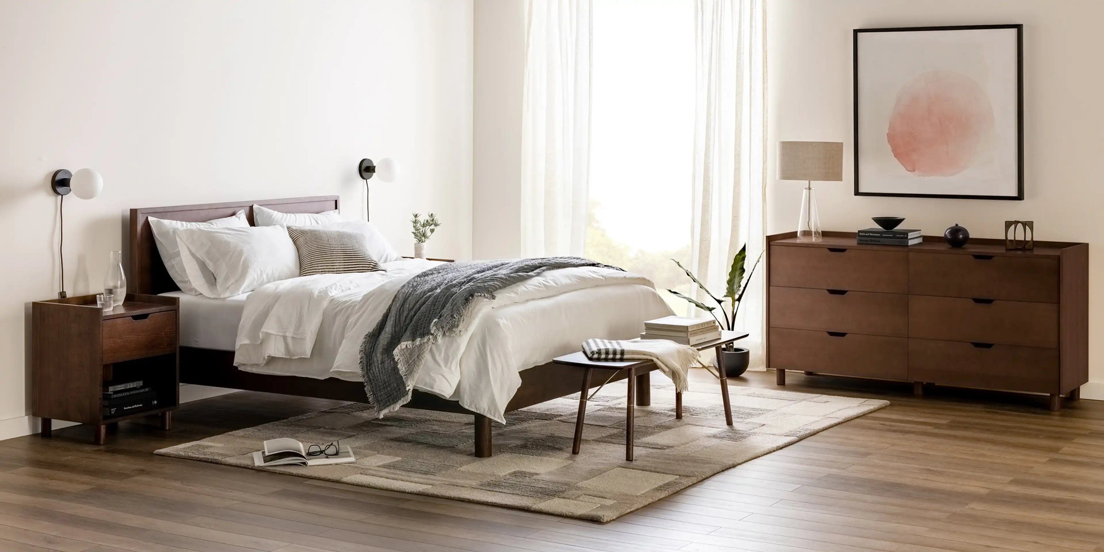 Peaceful bedroom with a Chorus walnut bedframe and spacious Great Plains area rug