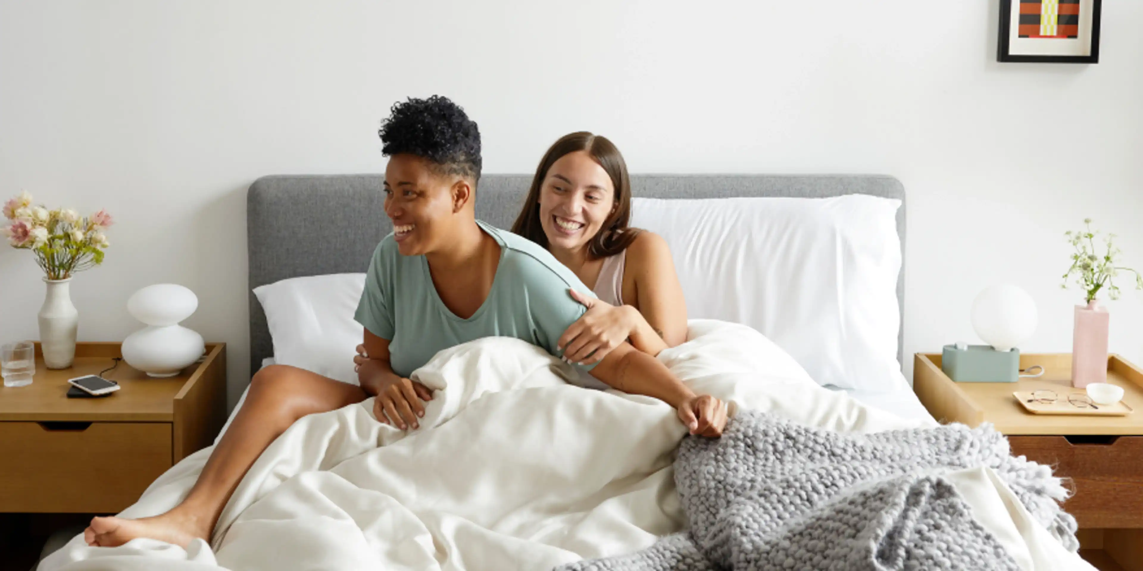 Happy couple in Chorus Upholstered Bed with Prospect Nightstands