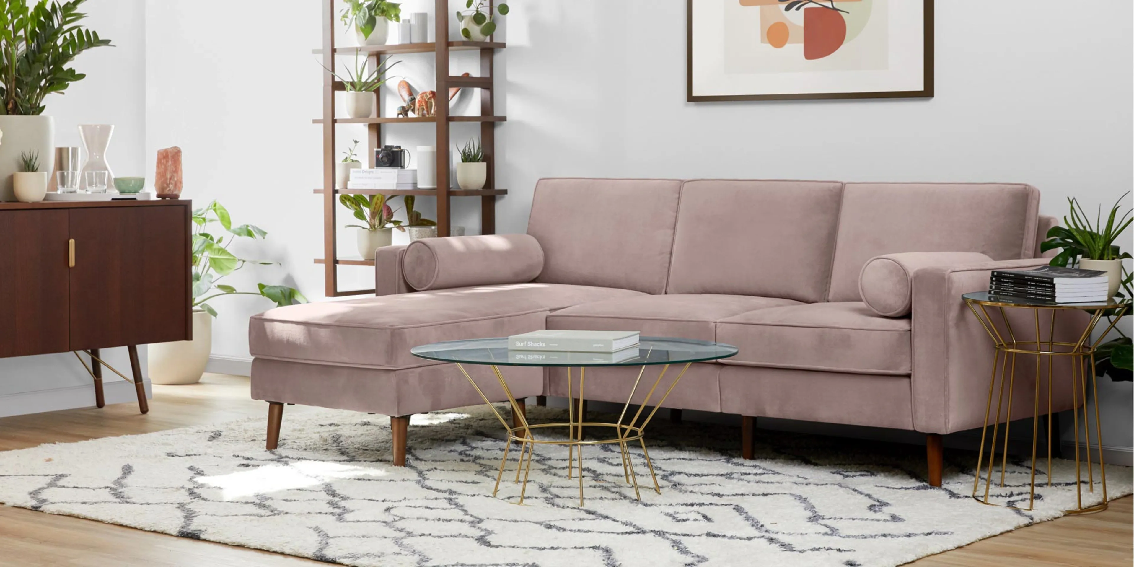A botanical, bohemian living area, with a dusk-colored velvet sectional