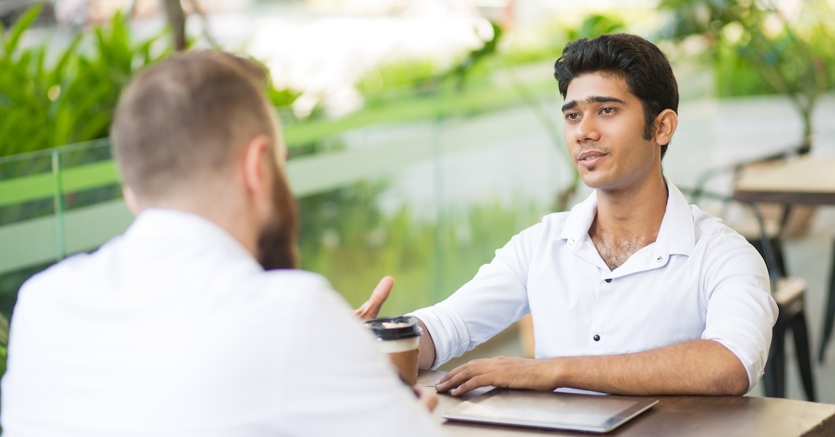 two men in business meeting outside