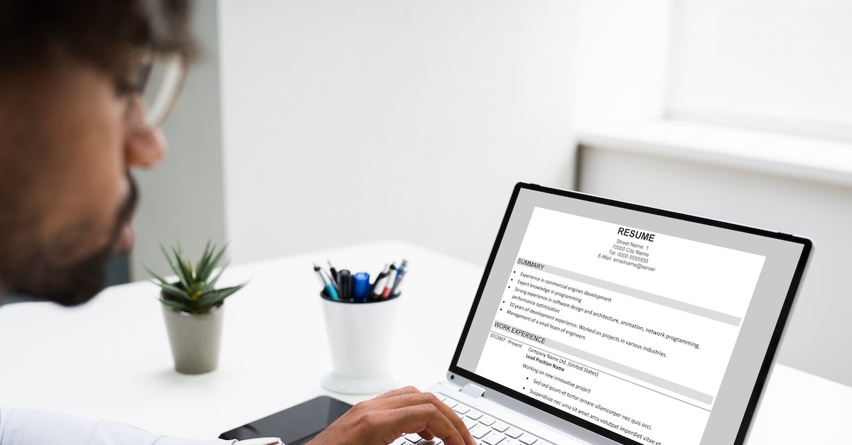 man creating a resume and portfolio on his laptop