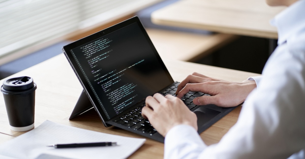 Man coding on laptop