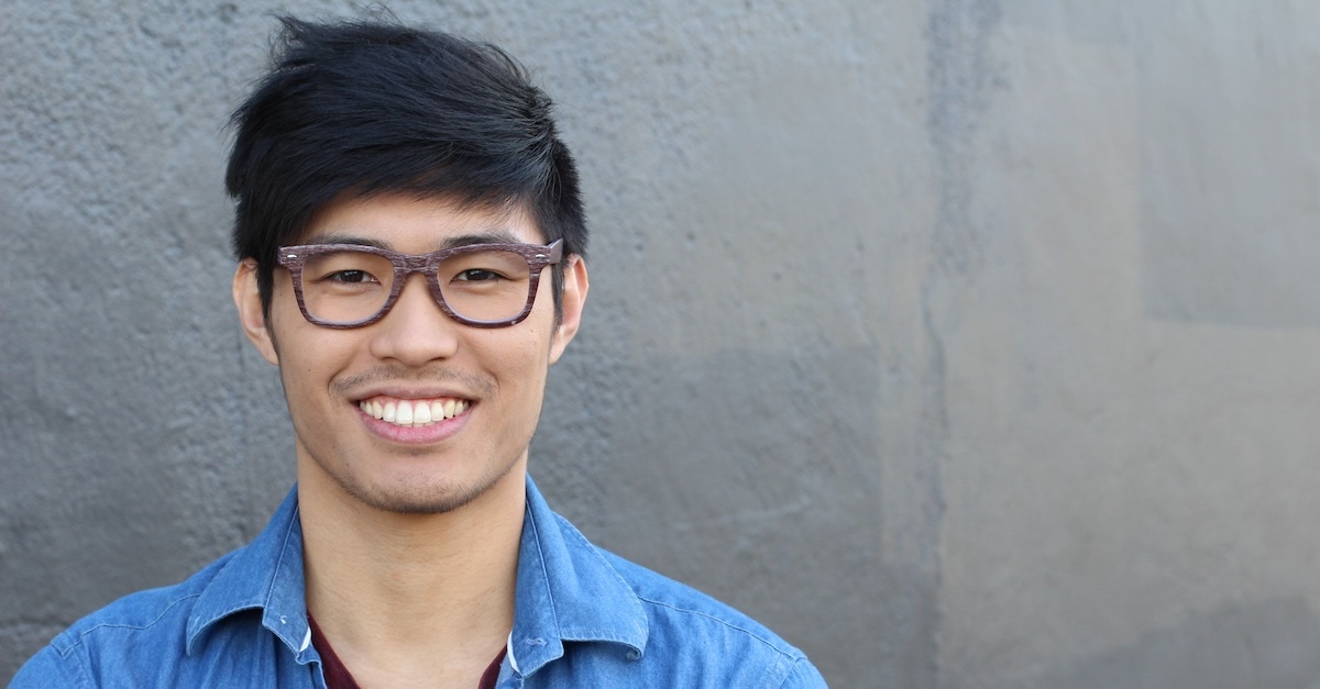 man in front of grey wall