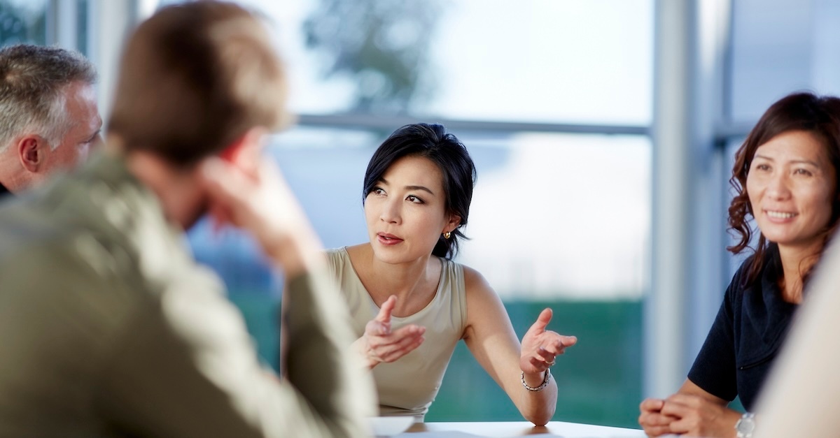 A group of four people reviewing job candidates