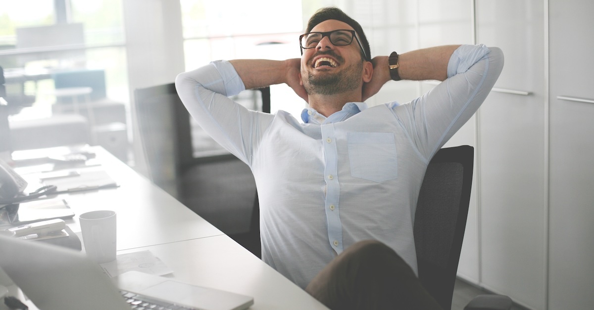 man stretching at his desk