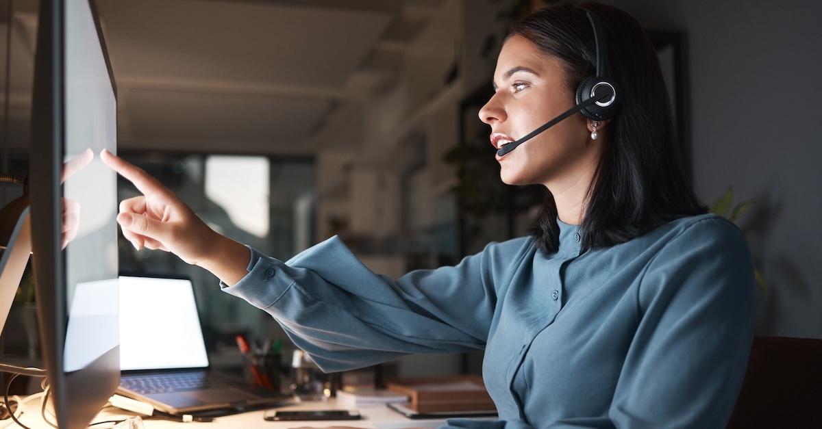 Woman with headset working on a computer