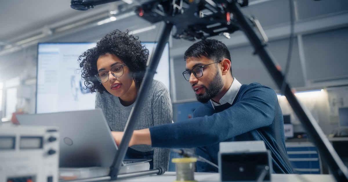 Man and woman wearing glasses working together