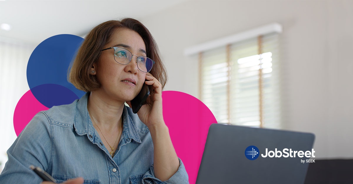 A worried middle aged woman talking on a phone while discussing redundancy