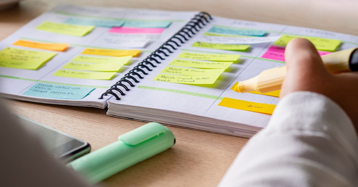 Woman using a highlighter in her work schedule planner