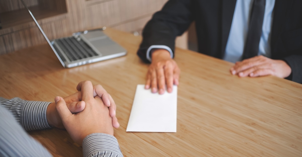 man handing in his resignation to boss