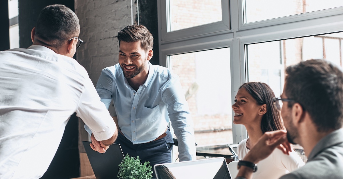 group during a meeting with handshake