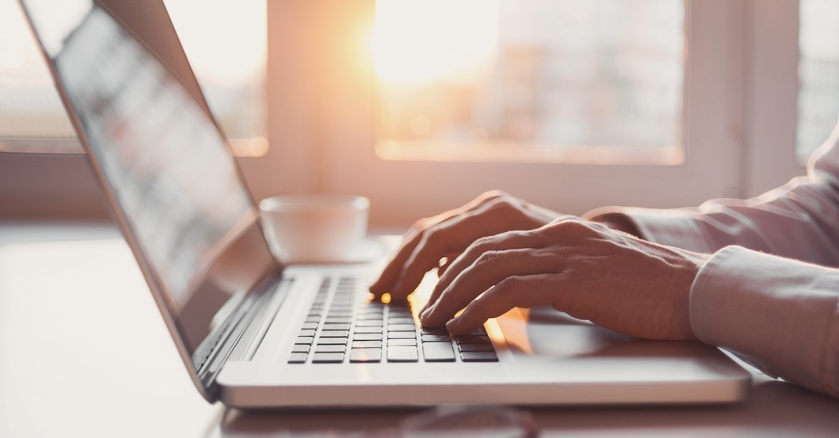 Man typing on a laptop