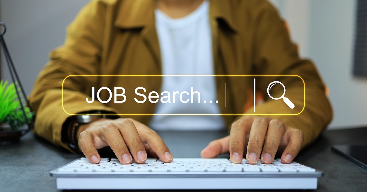 man in yellow jacket using a keyboard with job search