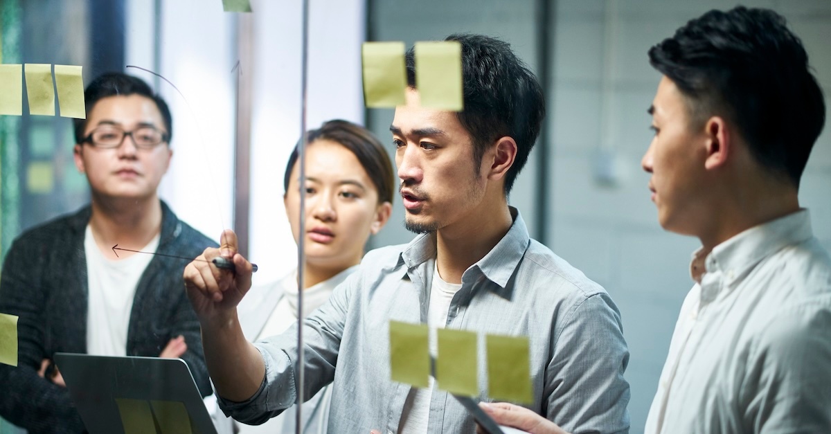 Group writing on idea board