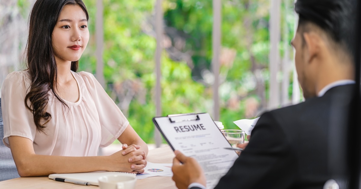 Woman in an interview with a man viewing her resume