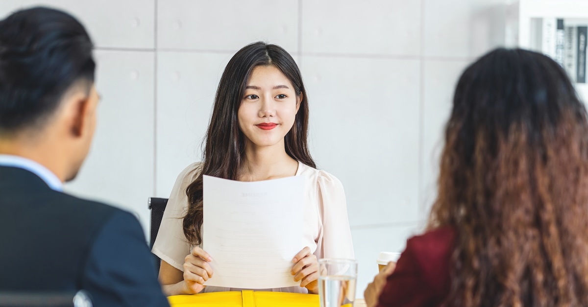 Woman interviewing two people