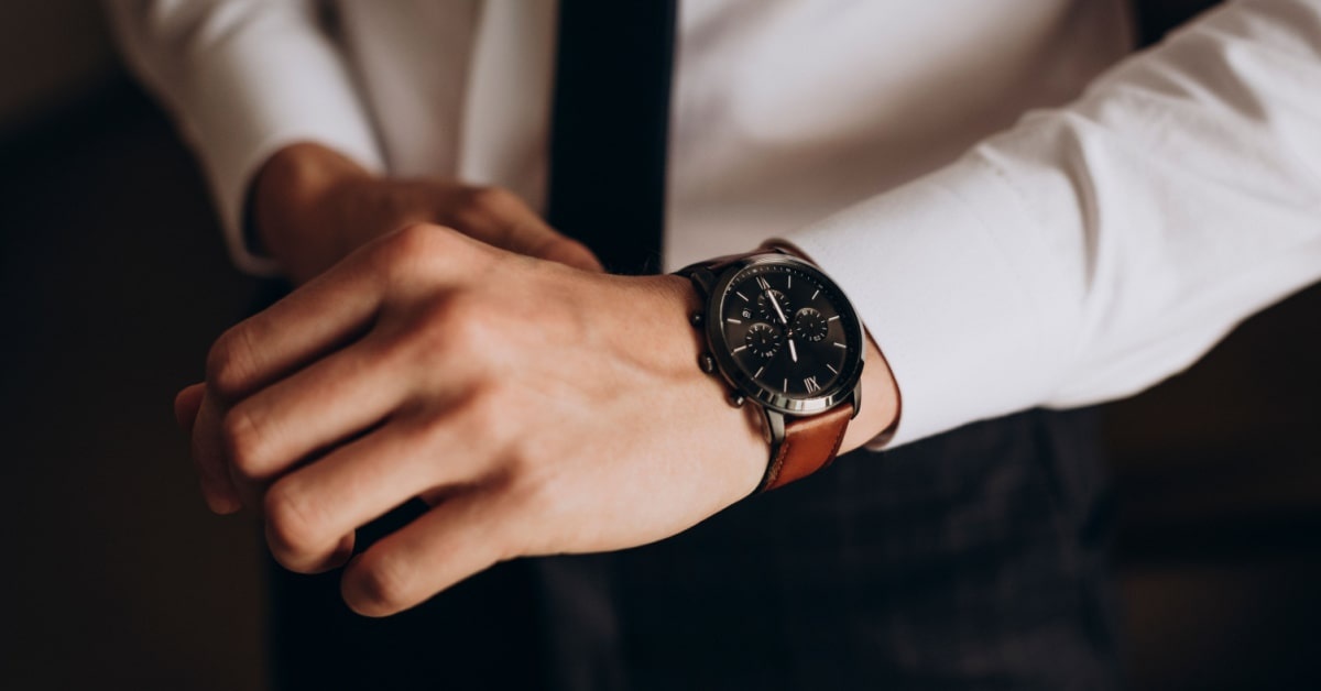 Hand of a man wearing watch a sample of business casual accessories for men
