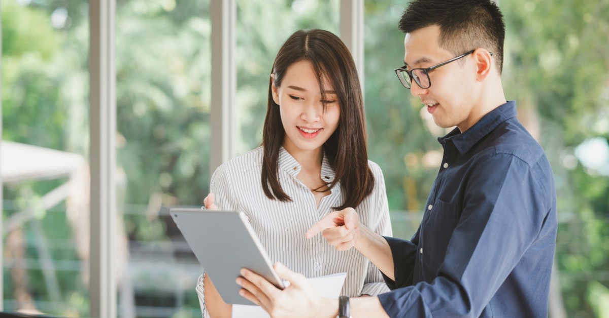 man and woman identifying strengths on resume