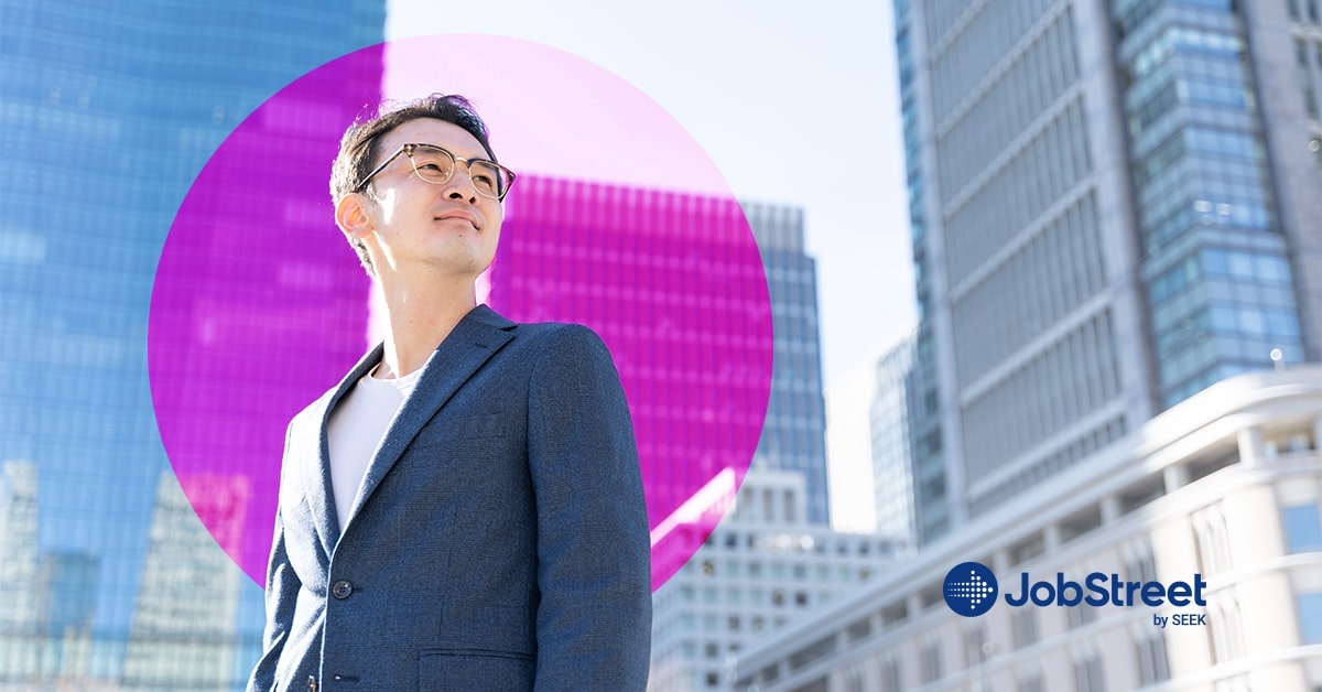 A businessman looking at the buildings while wearing business casual clothes for men