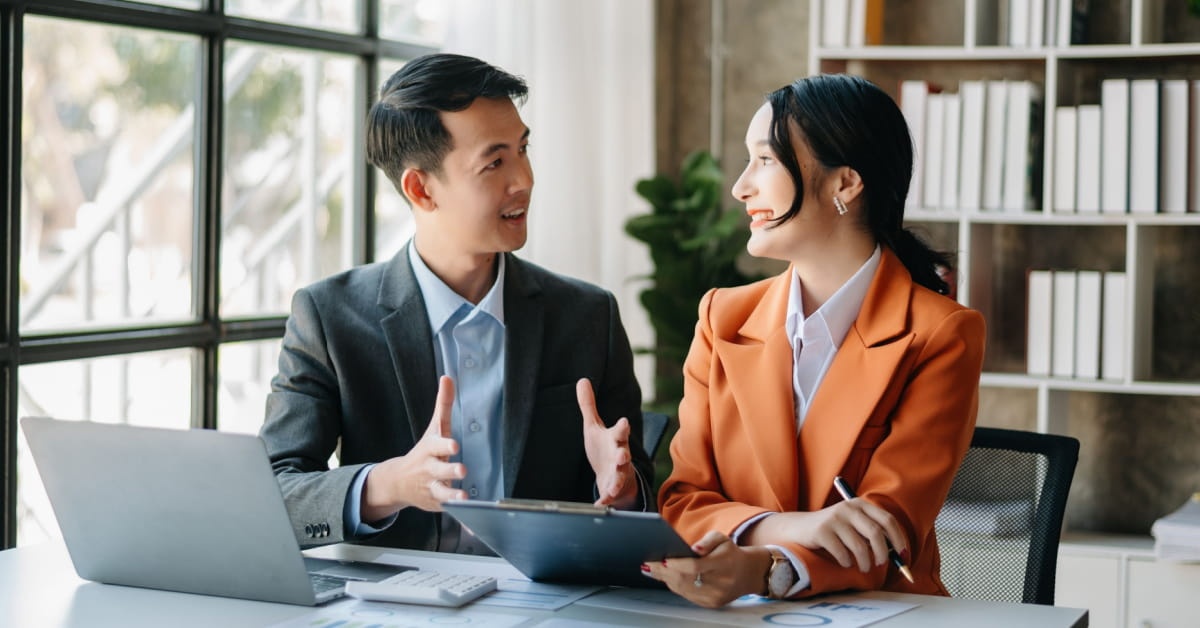 man welcoming new colleague to office