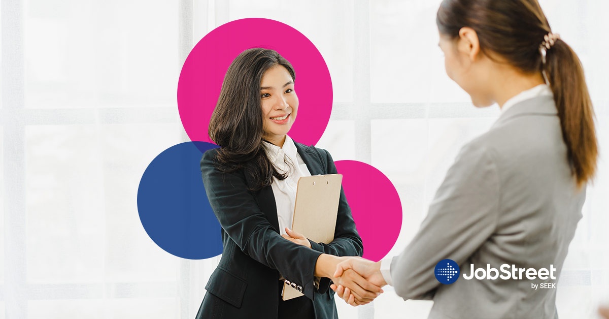 A woman shaking hands with the employer