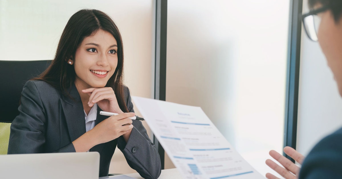 A focused girl sitting in a well-lit room, participating in a job interview