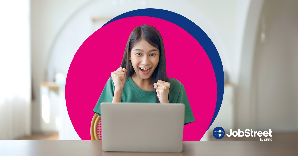 An excited woman looking at her laptop