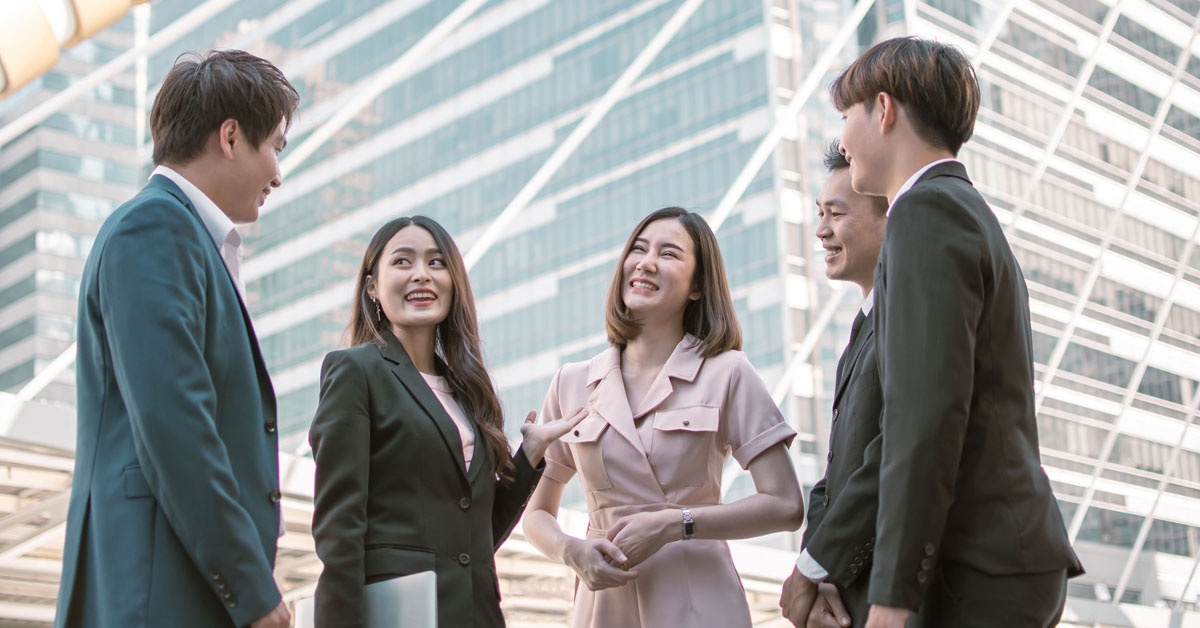 A joyful group of people standing together and smiling