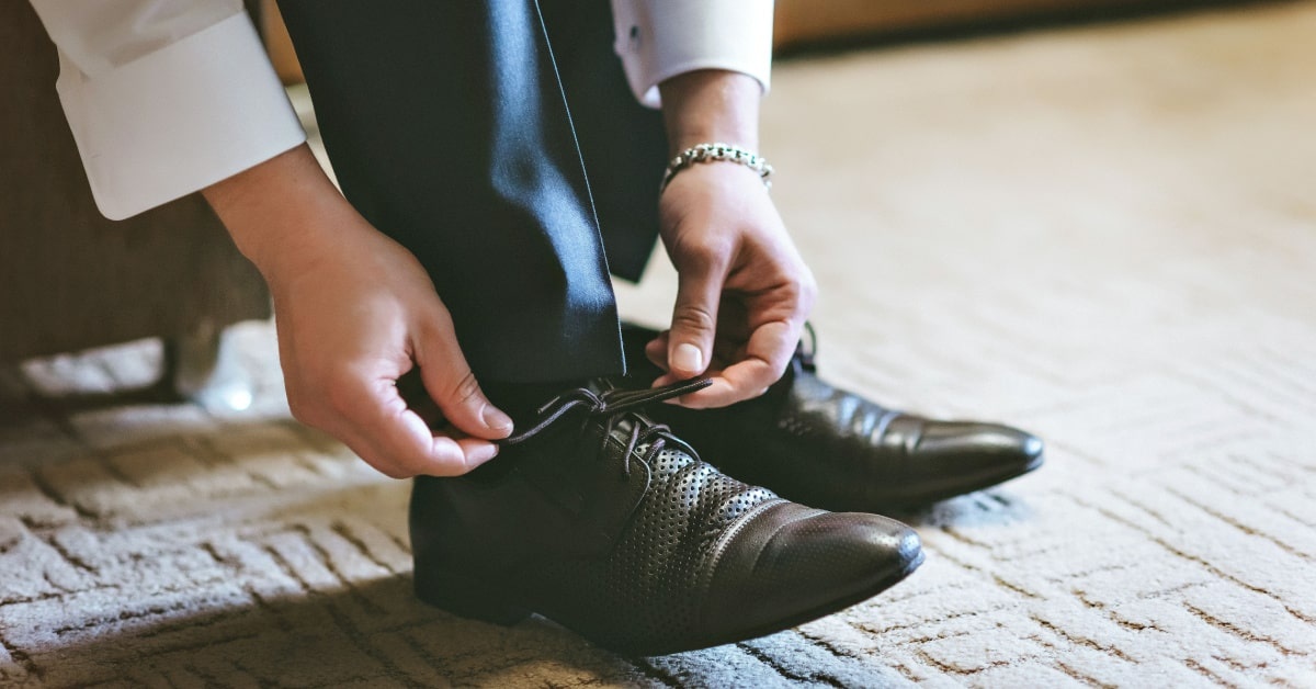 A man tying the know of his shoes