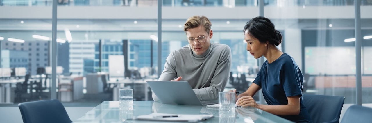 Man and woman working together at a desk