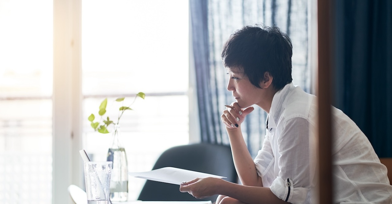 asian woman sitting and thinking