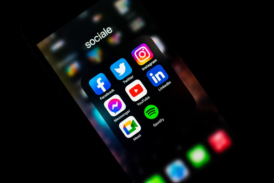 an iPhone showing the social media folder with all of the popular social media applications