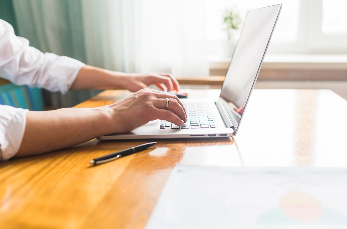 Side view of a man typing on a laptop