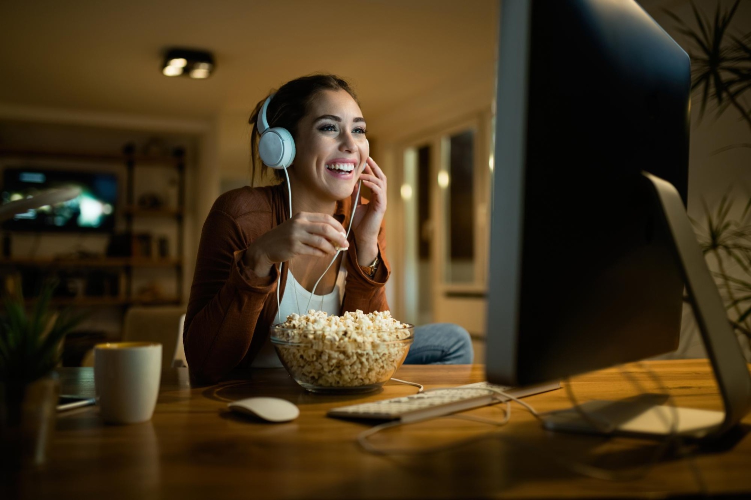 happy woman eating popcorn watching movie desktop