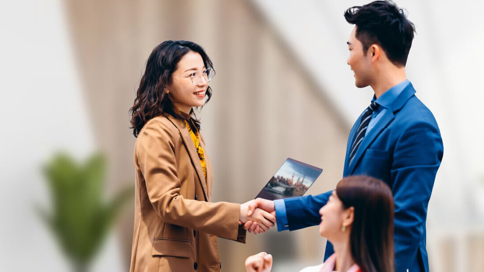 Woman shaking hands with a man