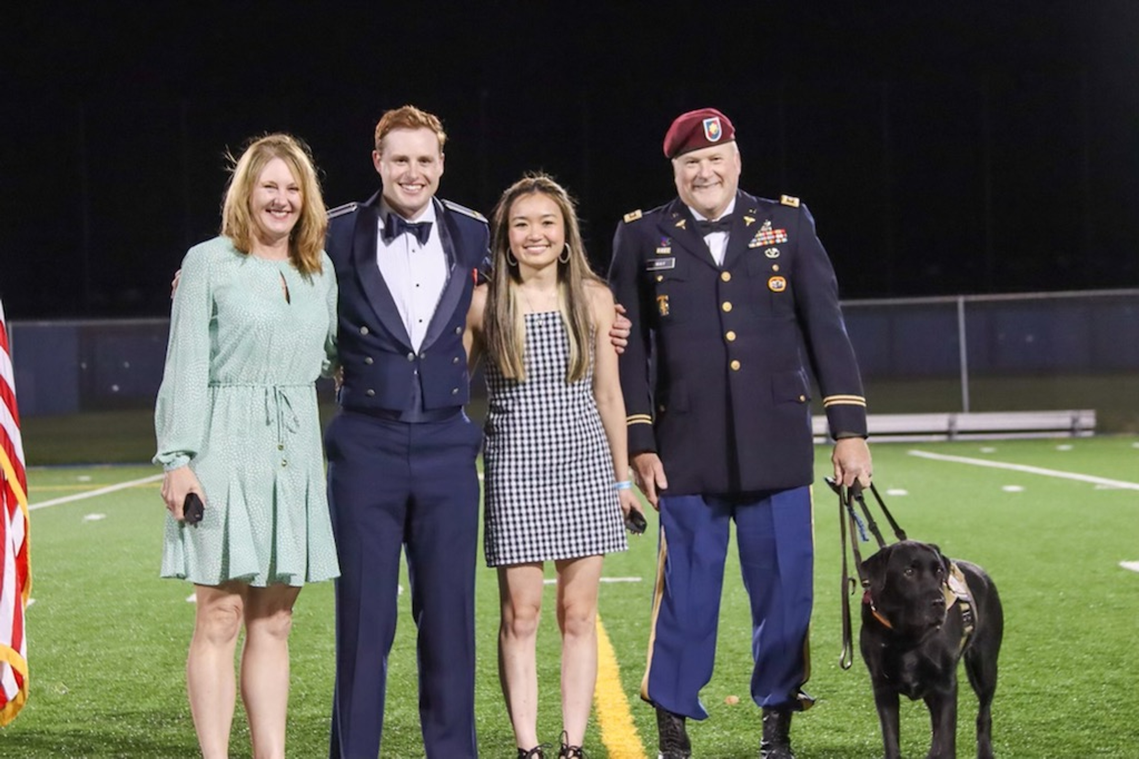 Pete Way posing with his family and dog