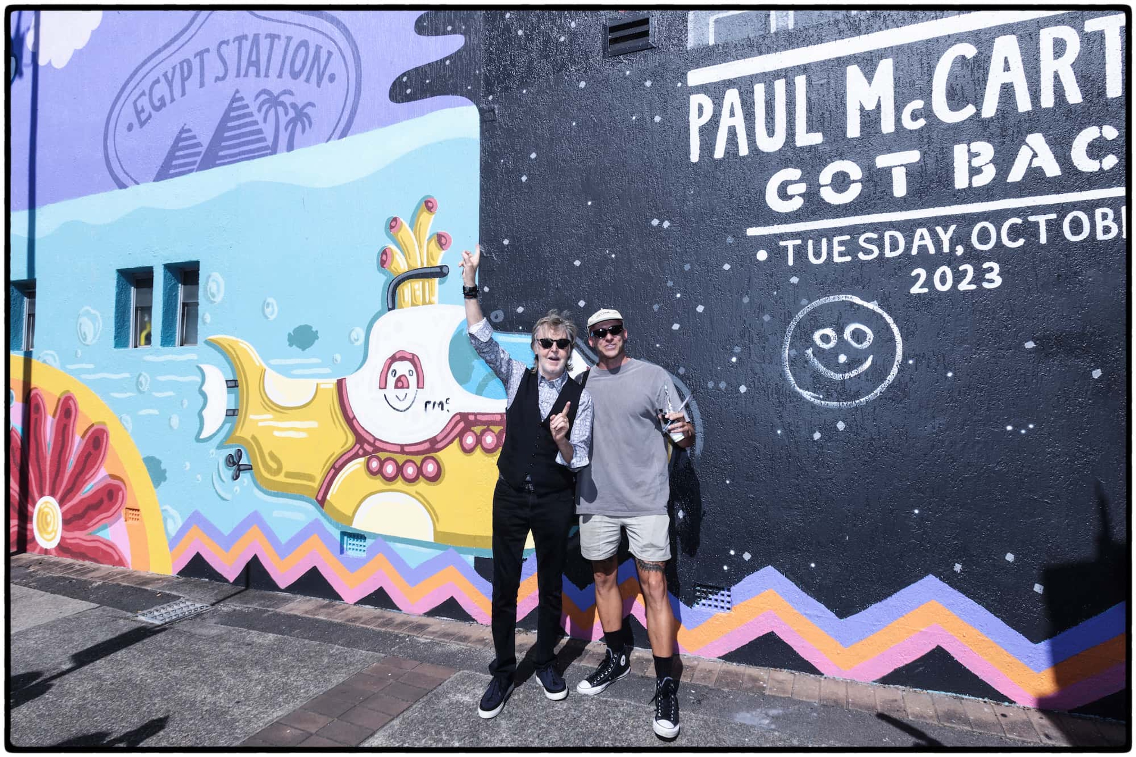 Paul and muralist Mitch Revs next to the large Paul McCartney themed 160sqm mural in Newcastle, Australia.