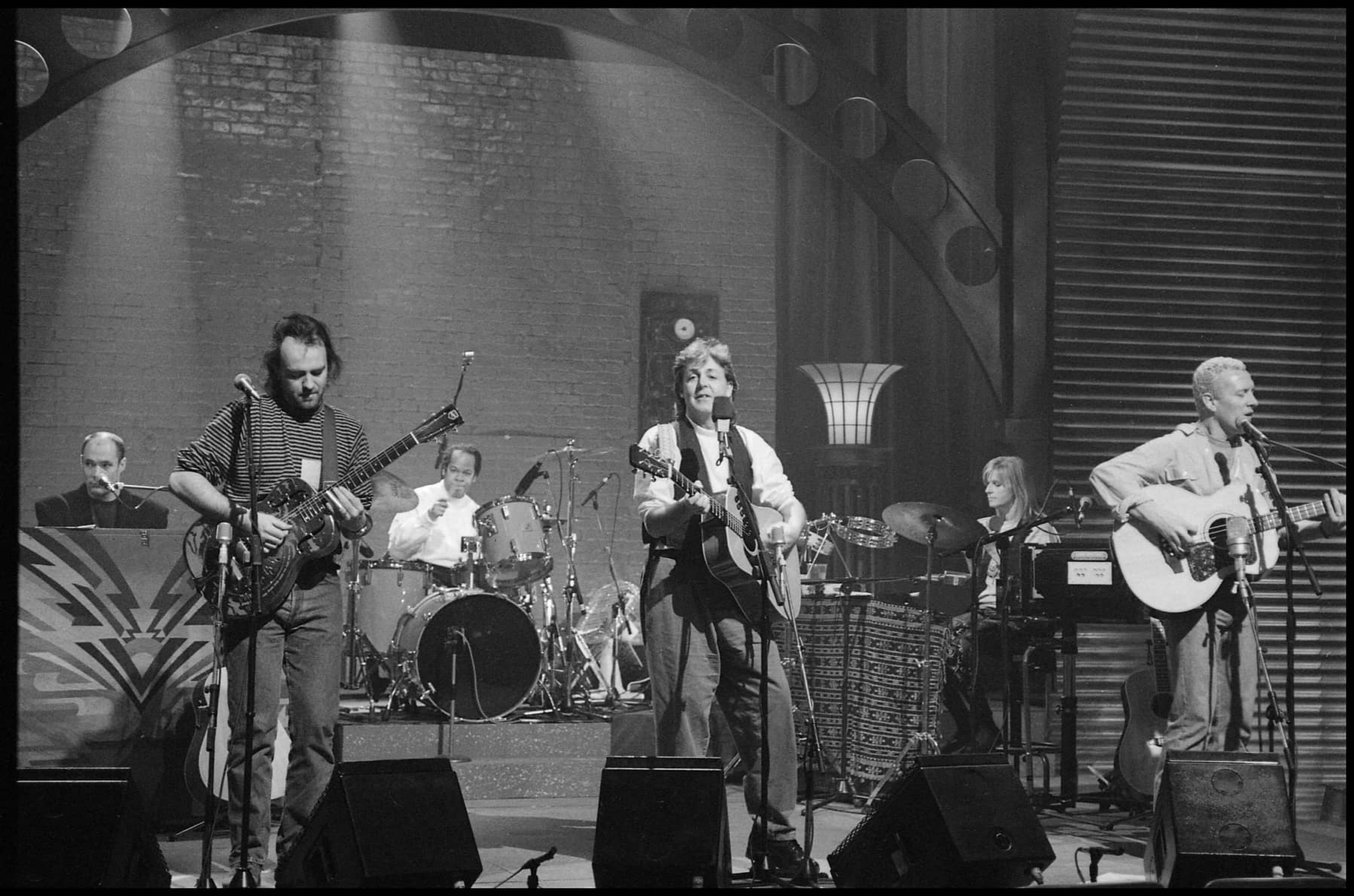 Photo of Paul and the band performing at MTV Unplugged at Limehouse Studios, London.